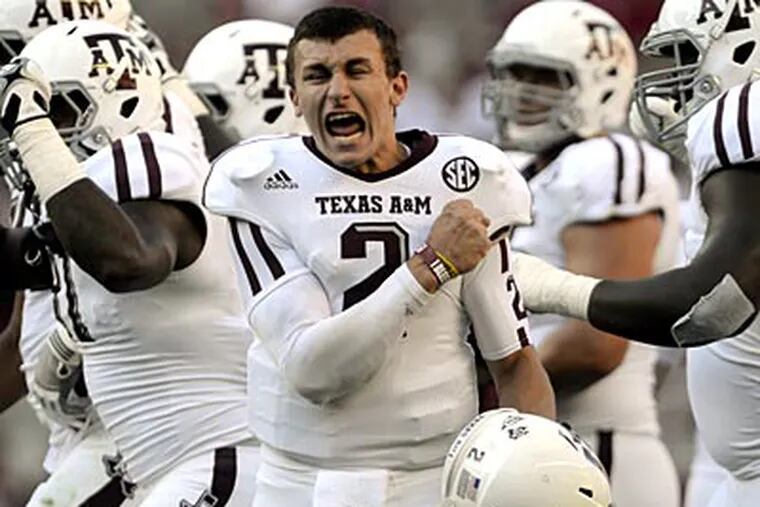 Texas A&M quarterback Johnny Manziel (2) celebrates after a review
proves an Aggie touchdown during the first half of their first SEC
meeting against and Alabama in an NCAA college football game,
Saturday, Nov. 10, 2012, in Tuscaloosa, Ala. No. 15 Texas A&M defeated
No. 1 Alabama 29-24.  (AP Photo/The Decatur Daily, Gary Cosby Jr.)