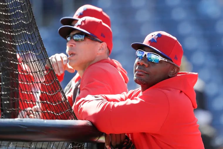 Phillies guest instructor Ryan Howard watching batting practice with manager Joe Girardi before Sunday's game against the Pirates.