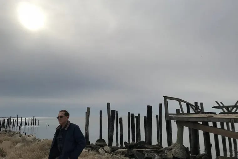 Elmer &quot;Skip&quot; Bowman, 78, Deputy Mayor of Lawrence Township, stands in front of one of 20 homes being razed in the township's Bay Point hamlet on the Delaware Bay.