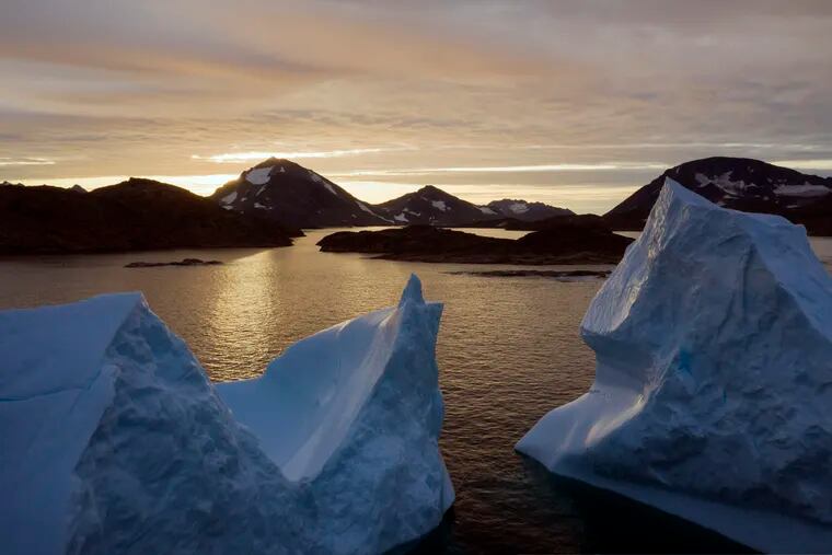 An aerial view of large Icebergs floating as the sun rises near Kulusuk, Greenland, early Friday, Aug. 16, 2019. Greenland has been melting faster in the last decade and this summer, it has seen two of the biggest melts on record since 2012. (AP Photo/Felipe Dana)