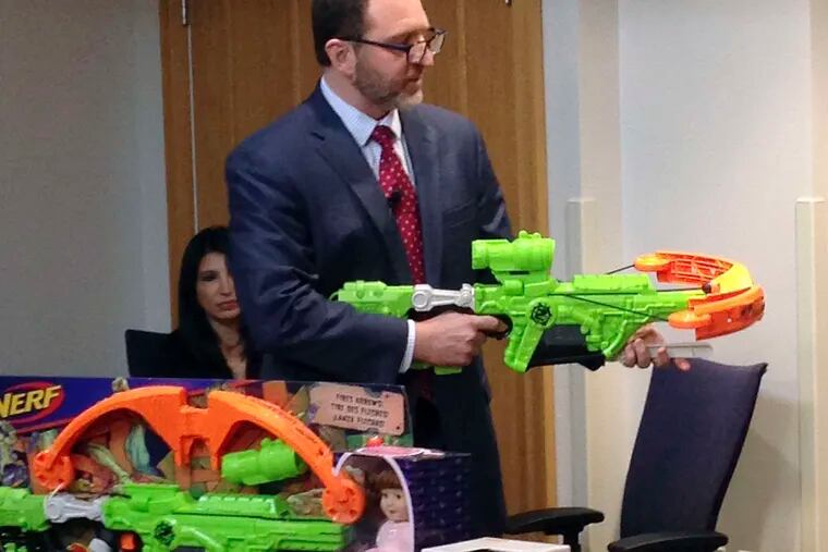 James Swartz, director of World Against Toys Causing Harm, or WATCH, displays Nerf's &quot;Zombie Strike&quot; crossbow.