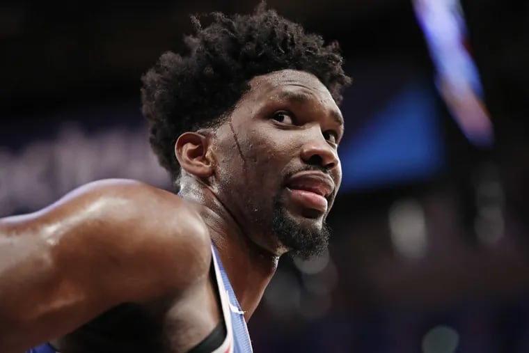 Joel Embiid talks to fans during the second half against the Knicks.