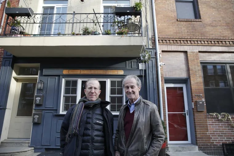 Jeff Goldman, left, and Joel Palmer, right, gather near the corner of 8th Street and St. Albans Street, a former VFW building that they saved and sold.