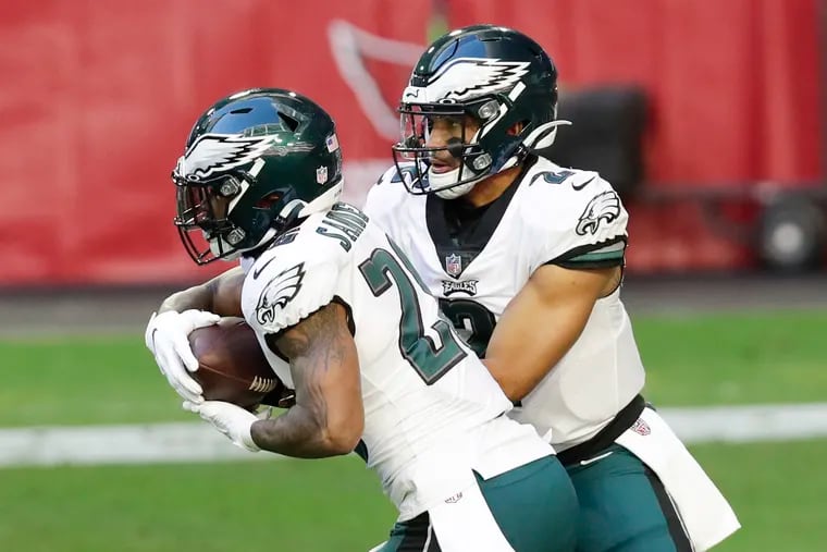 Eagles quarterback Jalen Hurts hands off to running back Miles Sanders against the Arizona Cardinals on Sunday.