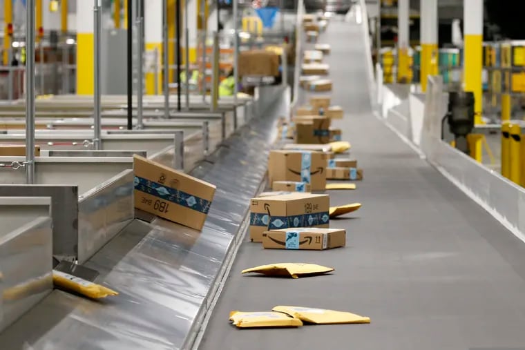 Packages moving along a conveyor at an Amazon warehouse facility in Goodyear, Ariz. Delaware officials approved plans to aid Amazon’s largest-ever “fulfillment center” on the site of a demolished General Motors plant west of Wilmington.