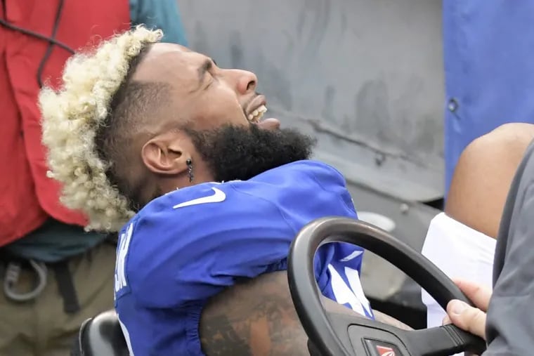 New York Giants wide receiver Odell Beckham Jr. reacts while being carted off the field after suffering a fractured ankle that ended his season. (AP Photo/Bill Kostroun)