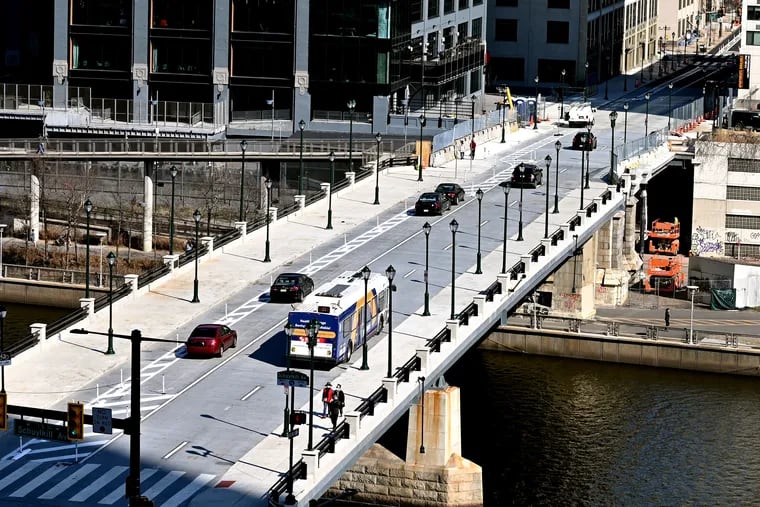 Pedestrians cross and traffic moves on the just-reopened Chestnut Street Bridge Mar. 21, 2022.