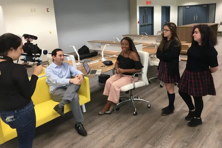 In the new Particle coworking space, String Theory School videographer in training Theresa Garcia (left) captures a meeting with school CIO Jason Corosanite, Stimulus CEO and mentor Tiffanie Stanard, and her student writing and graphics collaborators Jillian Mayer and Alexa Pagan.