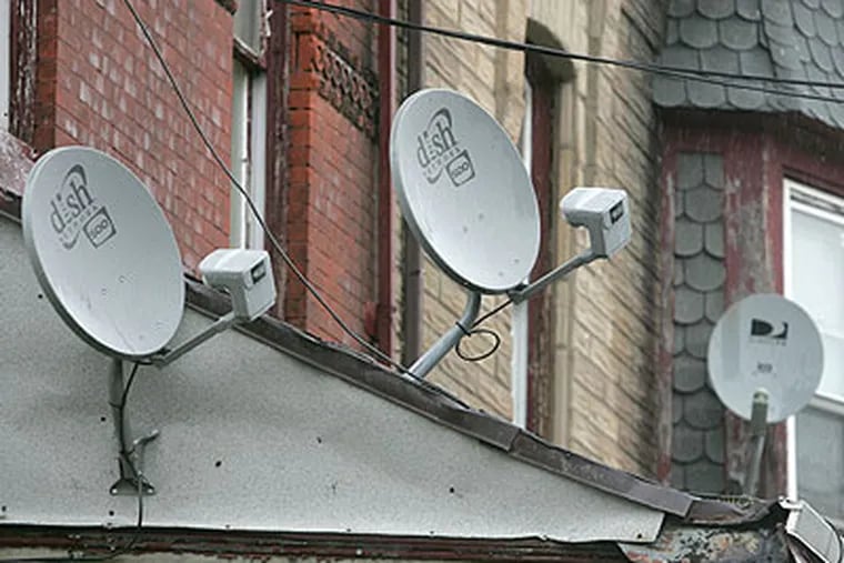 City Councilman Darrell Clarke has introduced a bill banning the placement of satellite dishes on the front facades of buildings. The legislation, which is expected to come to a vote next Thursday, would also require satellite providers (DirecTV, Dish, etc.) to remove dishes once a subscriber has discontinued service. These dishes are on homes in the 3100 block of C.B. Moore in the Strawberry Mansion section. (Charles Fox / Staff Photographer)