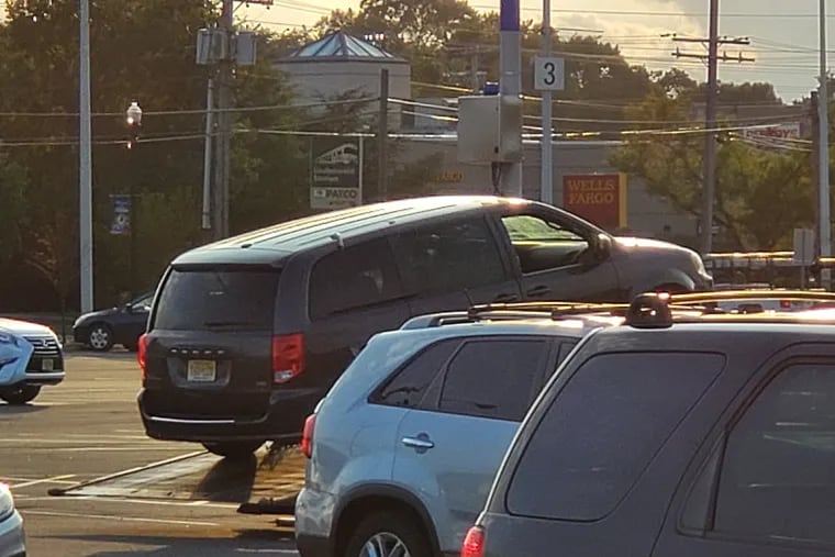 The Dodge Caravan in which a child died Friday, Aug. 16, 2019 being towed away from the PATCO station in Lindenwold, New Jersey.