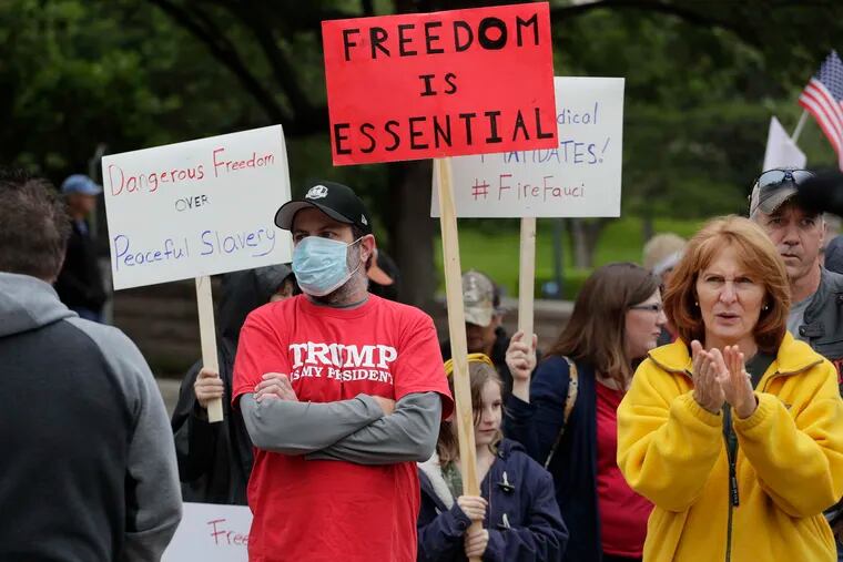 Protesters rally at the Texas State Capitol in Austin Saturday to speak out against the state's handling of the COVID-19 outbreak.
