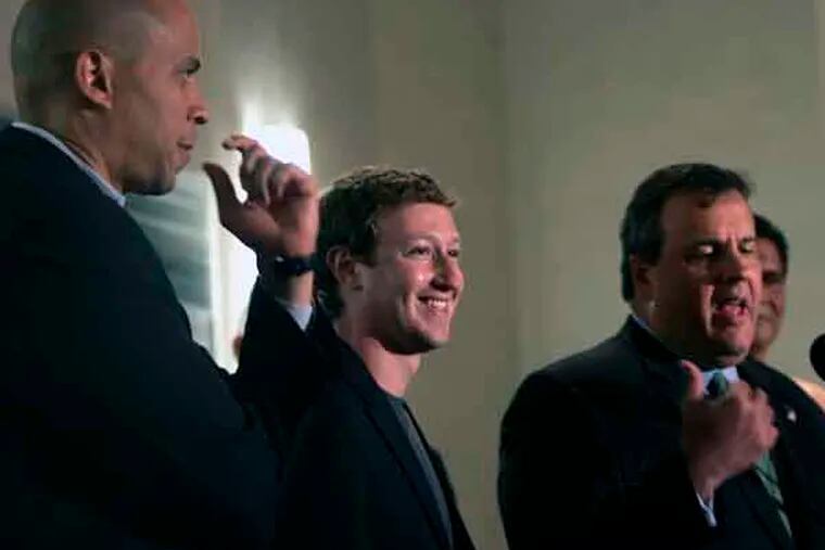 Newark Mayor Cory Booker, left, and Mark Zuckerberg, center, founder and CEO of Facebook listen as N.J. Gov. Chris Christie talks about the states schools, during a press conference at the Robert Treat Hotel in Newark, N.J., Saturday, Sept. 25, 2010. Zuckerberg is there to talk about his donation of $100 million to help Newark public schools   (AP Photo/Rich Schultz)