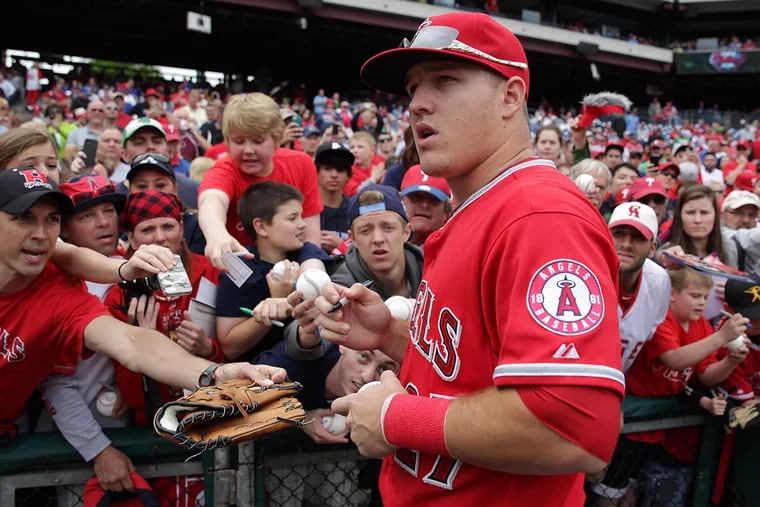 Mike Trout signs autographs during his last trip to Citizens Bank Park in 2014.