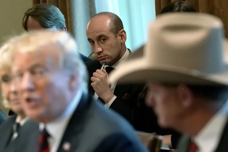President Donald Trump speaks as adviser Stephen Miller (center) listens during a round-table discussion on border security and safe communities with state, local, and community leaders in the Cabinet Room of the White House on January 11, 2019, in Washington, D.C. (Alex Wong / Getty Images / TNS)
