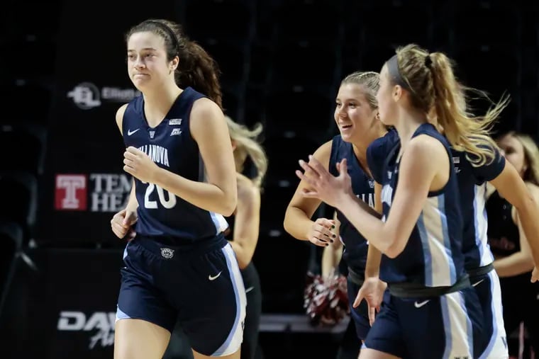 Villanova’s #20 Maddy Siegrist (left) runs off the court with her teammates who applaud after Siegrist scored 41 points during the Villanova at Temple University women's basketball game at Temple’s Liacouras Center in Phila., Pa. on Sun., Nov. 20, 2022.