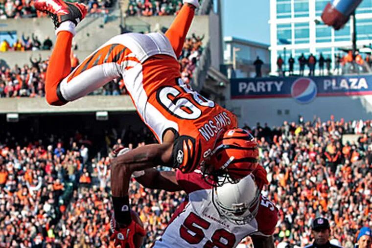 Bengals receiver Jerome Simpson flips over Cardinals line backer Daryl Washington for a touchdown. (Darron Cummings/AP Photo)