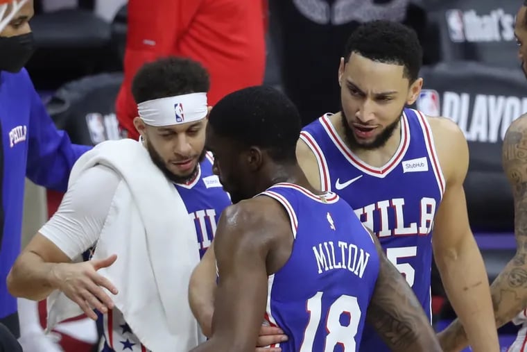 Shake Milton (center) is congratulated by Seth Curry (left) and Ben Simmons after their victory in Game 2.