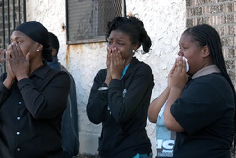 Mourners weep outside Eric Hayes&#0039; funeral. Hayes had seen someone try to torch his family&#0039;s home in Southwest Philadelphia. He was killed before he could finish testifying against the alleged arsonist.