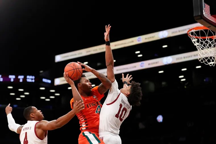 Miami's Keith Stone (4) shoots over Temple's Jake Forrester (10) during the first half of an NCAA college basketball game at Barclays Center, Tuesday, Dec. 17, 2019, in New York. (AP Photo/Michael Owens)