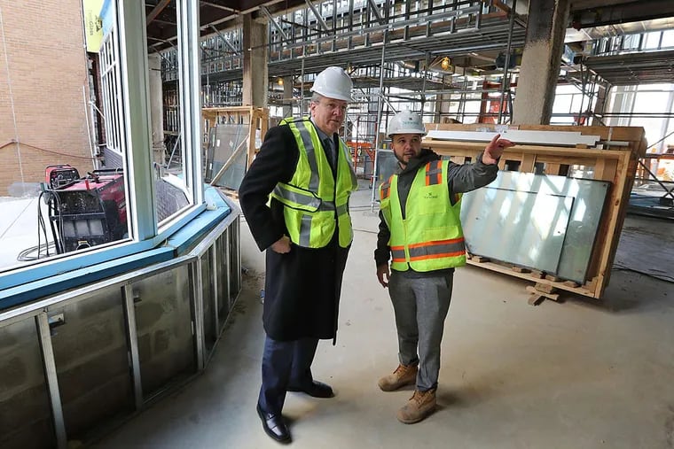Touring the construction site are CEO Joe Devine (left) and project manager Ryan Spotts.
