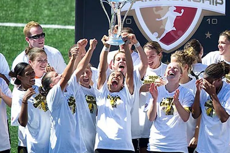 FC Gold Pride star Marta lifts the Women's Professional Soccer championship trophy. (John Todd/ISI Photos)