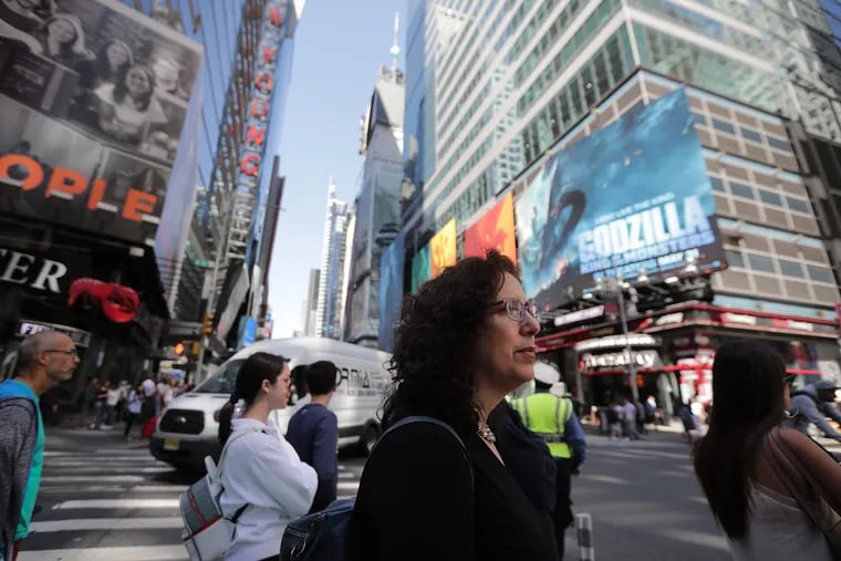 Mara Isaacs, one of the producers for the musical "Hadestown," navigates Times Square as she walks back to her office after a meeting in Manhattan, N.Y., on June 3, 2019. "Hadestown" is nominated for 14 Tony awards, including Best Musical.