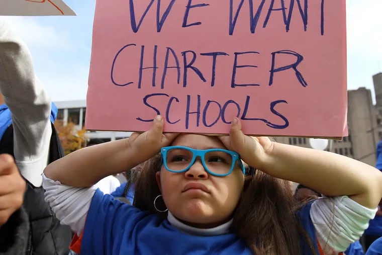 Adessa Lewis, a KEPA 1st grader, holds a sign in front of the Philadelphia School Administration building during a rally supporting new charter schools in Philadelphia on November 11, 2014. ( DAVID MAIALETTI / Staff Photographer )