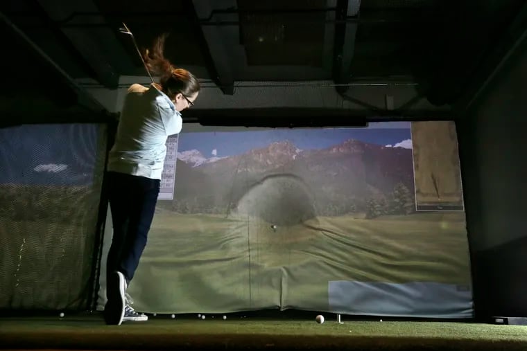 Amy Venuto of Phila. watches the trajectory of her shot while using the TrackMan Pro golf simulators at Golf and Social on Delaware Ave. in Phila., Pa. on February 16, 2019.