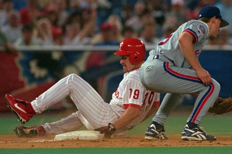 Kevin Stocker, here sliding into third base past the Expos’ Doug Strange for a triple in 1997, is one of three additions to the Phillies radio booth.