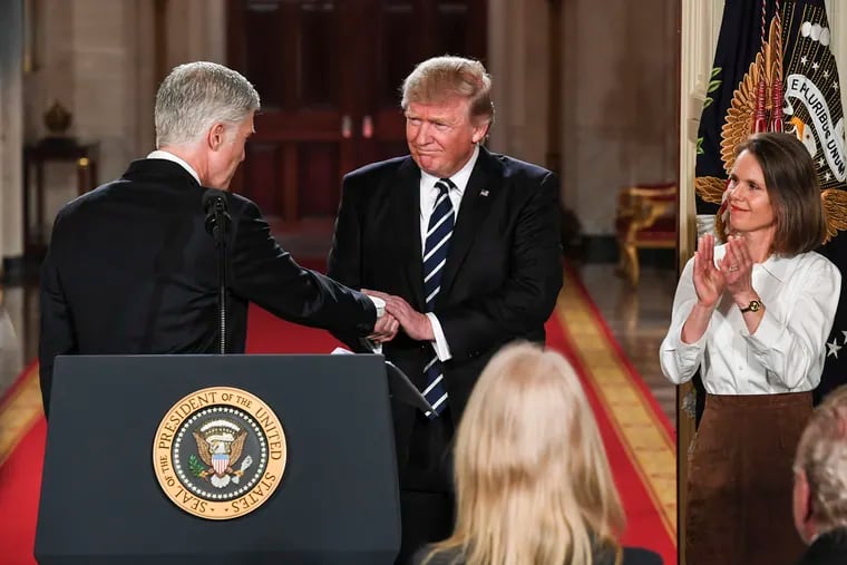 President Trump welcomes Neil Gorsuch during a the announcement of his nomination to the Supreme Court on Jan. 31. The judge is kissing his wife, Marie Louise.