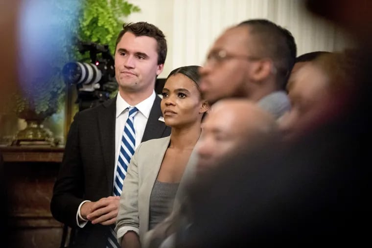 Conservative commentator and conservative advocacy group Turning Point USA Director of Communications Candace Owens, center, listens as President Donald Trump speaks at the 2018 Young Black Leadership Summit in the East Room of the White House, Friday, Oct. 26, 2018, in Washington.