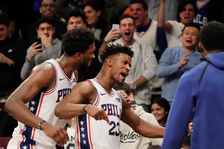 Sixers star Jimmy Butler (right) celebrates his game-winning shot with Joel Embiid.