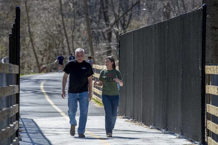 Barry Pinkowicz (left), president of the Friends of Chester Creek Trail, and Sarah Clark Stuart, ex. director of the Bicycle Coalition of Greater Philadelphia, take a walk along the newly dedicated bike/walking path along the Chester Creek in Middletown, Delaware County April 9, 2017.  Pinkowicz and his group have been working on getting the trail built (on old railroad tracks) for more than 20 years. CLEM MURRAY / Staff Photographer