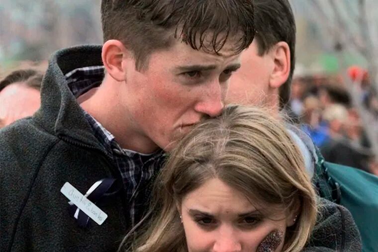 FILE - In this April 25, 1999 file photo, shooting victim Austin Eubanks hugs his girlfriend during a community wide memorial service in Littleton, Colo., for the victims of the shooting rampage at Columbine High School the previous week. Eubanks, who survived the 1999 Columbine school shooting and later became an advocate for fighting addiction has died. Routt County Coroner Robert Ryg said Saturday, May 18, 2019, that 37-year-old Eubanks died overnight at his Steamboat Springs home. A Monday autopsy was planned to determine the cause of death.