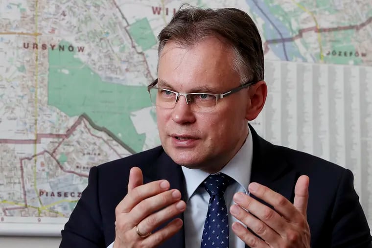 Poland's ruling party lawmaker Arkadiusz Mularczyk talks to The Associated Press in the parliament building in Warsaw, Poland, on Tuesday, May 21, 2019, about a report that assesses Poland's World War II losses and that, he says, will be given to German government. Contrary to Germany claims, Mularczyk says there are no documents or records suggesting that Poles has ever renounced its right to seek reparations from Berlin.(AP Photo/Czarek Sokolowski)