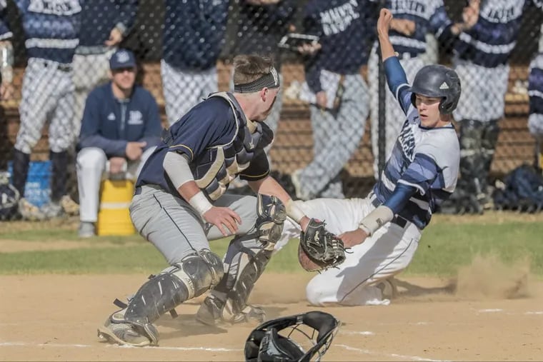 Brady Devereux of Malvern Prep is tagged out by Penn Charter catcher Gavin Zavorski, left, in a game from last season. Devereux homered on Friday as Malvern Prep beat Haverford School.