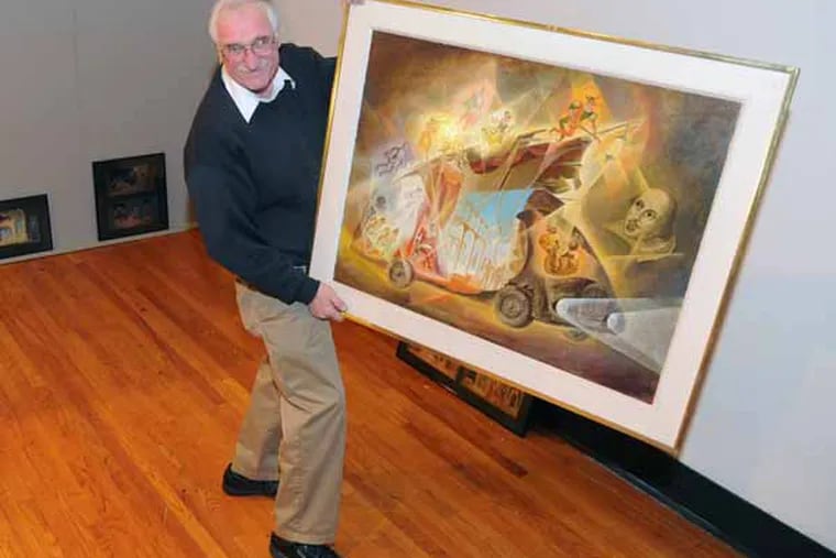 Peter Dajevskis, son of Latvian artist Evald Dajevskis, holds and explains a 1975 painting by his dad titled The Dreadnought to Maija Mednis, 79, on Jan. 24, 2013 at the Latvian Society in Philadelphia where a show of some of Dajevskis' artwork is being hung. Ms. Mednis is a native Latvian living in Blackwood, NJ.  She was placed in a "displaced persons camp" during WWII and show theater shows in the camp whose sets were designed by the artist Evald Dajevskis. ( CLEM MURRAY / Staff Photographer )