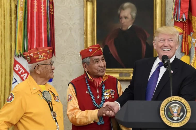 President Donald Trump meets with Navajo Code Talkers Peter MacDonald (center) and Thomas Begay (left) in the Oval Office on Monday.