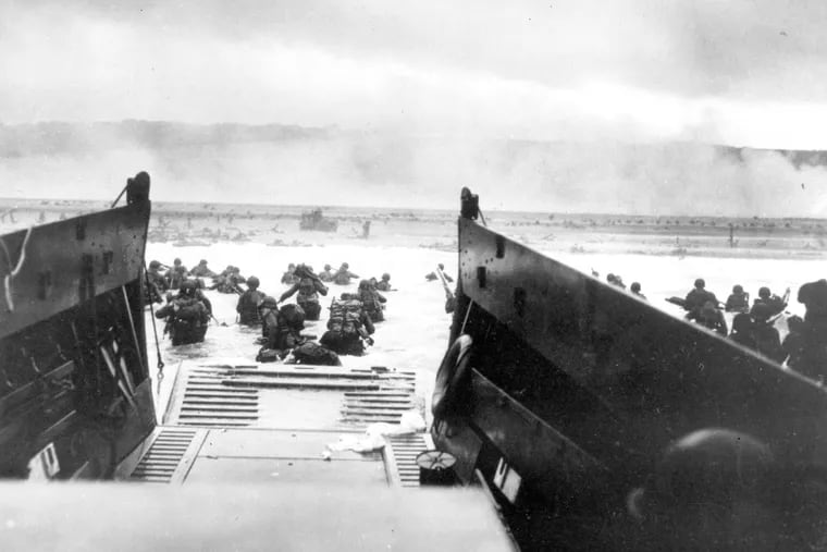 American infantrymen wade ashore off the ramp of a Coast Guard landing craft during the invasion of the French coast of Normandy in World War II on June 6, 1944.