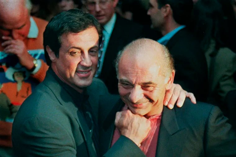 In this Nov. 15, 1996, file photo, Sylvester Stallone, left, mugs with "Rocky" co-star Burt Young before a screening of the 1976 film to celebrate its 20th anniversary, at the Academy of Motion Picture Arts & Sciences in Beverly Hills, Calif. Amazon bought the rights to “Rocky” with its purchase of MGM. (AP Photo/Chris Pizzello, File)