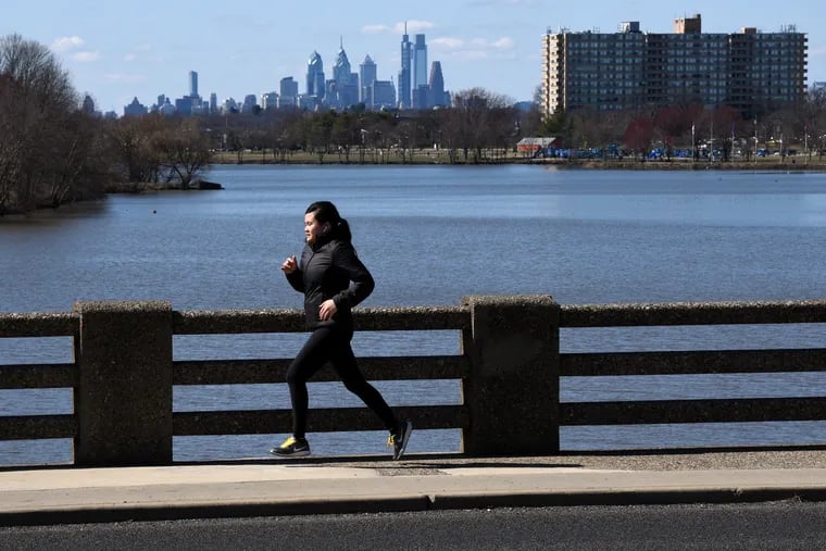 A runner crosses the bridge over the Cooper River on East Cuthbert Blvd. in Cherry Hill on Sunday. There are essentially no options for entertainment as the region is occupying itself with the coronavirus outbreak and its tightening grip on every aspect of public life.