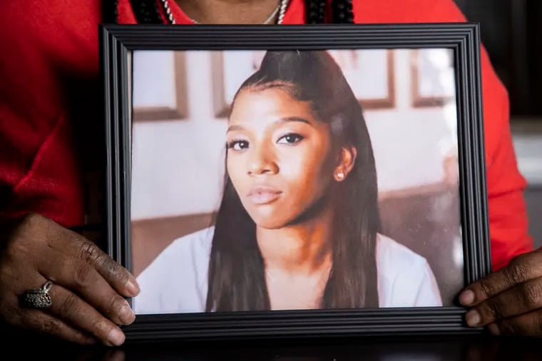 Rhonda Pack Terry holds a photograph of her daughter, Ebony Pack, at her home in Feasterville in 2020. Pack was killed as she was stopped at a red light in Lansdale.