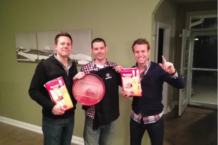 Ryan Kautzer, left, a lawyer, at his man shower with friends Nick Mees, middle, and Kyle Kaufman. Kautzer enjoyed the competitive events at his March 2014 man shower, but he also appreciated the “load of diapers, wipes, and pajamas that the guys brought,” he said.
