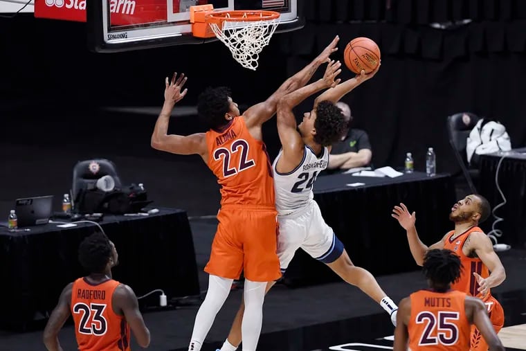 Villanova's Jeremiah Robinson-Earl, center right, goes up for a basket as Virginia Tech's Keve Aluma defends during the first half on Sunday. Villanova lost, 81-73, in overtime and will now be playing its fourth game in seven days.