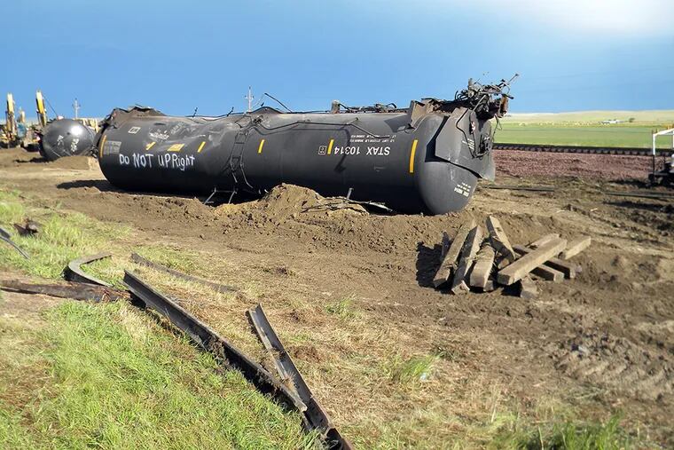 The Obama administration had said it would let notification rules lapse, but it relented in the face of protests. Here, a derailed tanker in Montana in July. (Associated Press)