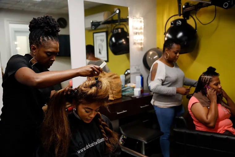 Kari Williams, left, who is an expert in hair and scalp care, said that common methods of straightening or chemically treating black hair often damage the hair and scalp. A new NIEHS study has linked breast cancer with hair dye and straightener.