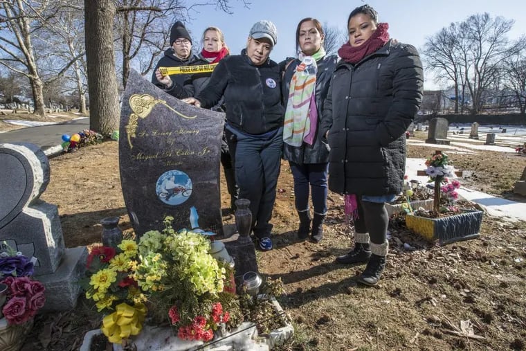 Waleska Baez, center, stands at Greenmount Cemetery next to the grave of her son, Miguel Colon, killed in April 2016, flanked by (left to right) Wilfredo Rojas and his ex-wife Aleida Gaecia, who lost their son Alejandro Rojas, Baez, Lisa Espinosa, who lost her son Raymond Pantoja and Roz Pichardo, who lost her brother, Alexander Martinez, 6 years ago.