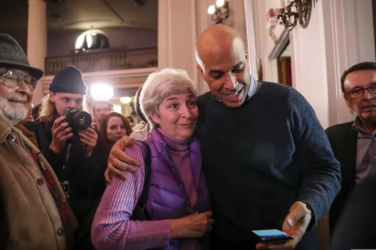 U.S. Sen. Cory Booker prepares to take a selfie with a supporter at a post-midterm-election victory celebration in New Hampshire in December. Booker has now launched a campaign for president.