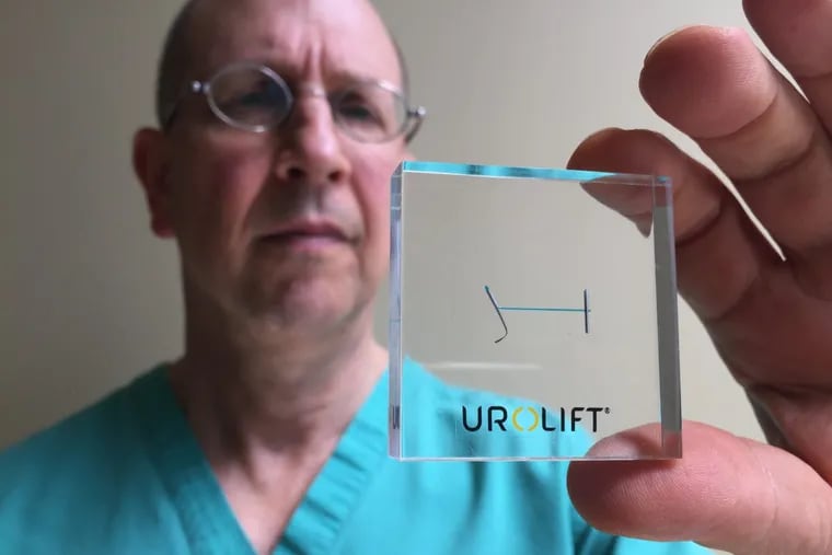To improve urinary flow in men with enlarged prostates, Philadelphia urologist Bruce Sloane implants special sutures such as the one shown here, encased in plastic for display purposes.