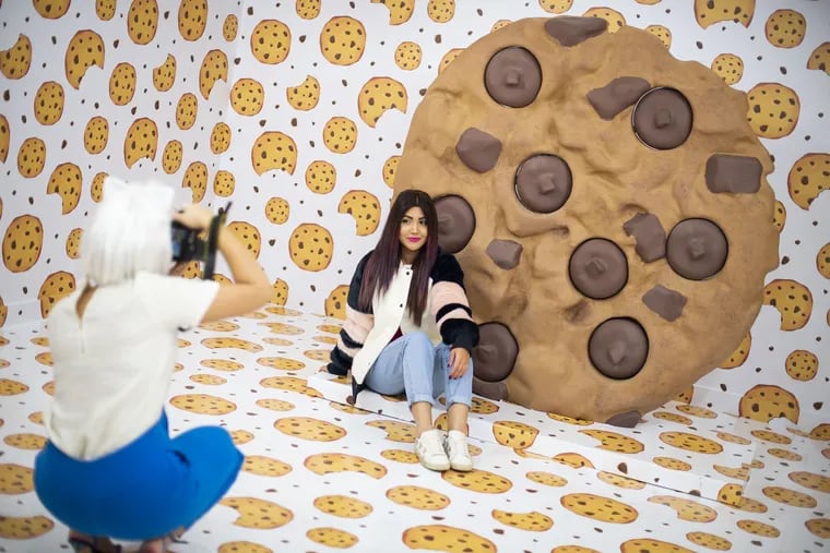 A young woman poses inside the popular Cookie Room where you can snap photos while  enjoying the aroma of fresh-baked cookies.